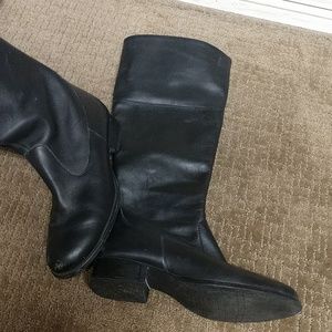 Women's black boots. Falls just below the knee